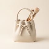 Sculptural drawstring makeup brush organiser in matte Bone, 3D printed vanity holder