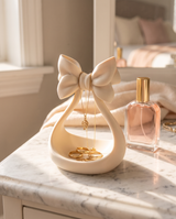 Coquette ribbon bow jewellery stand with gold necklaces draped over it