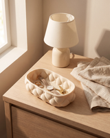 Tufted quilted vanity tray styled on a nightstand holding rings, a watch and keys