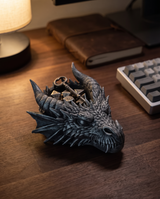 Dragon head catchall tray on a walnut desk holding dice and a key