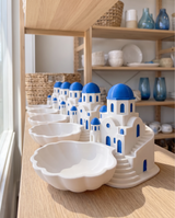 Santorini coastal catchalls merchandised in a row on a boutique shelf