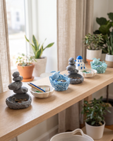 Coastal and nature assortment merchandised on a pale oak shop shelf