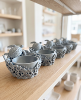 Sea turtle catchall bowls merchandised in a row on a boutique shelf
