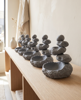 Zen stone cairn catchall trays merchandised in a row on a boutique shelf