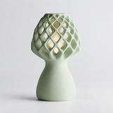 Glow Petal table lamp in Sage with light puck illuminated