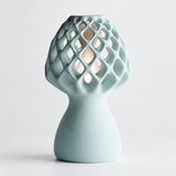 Glow Petal table lamp in Seafoam with light puck illuminated