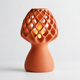 Glow Petal table lamp in Terracotta with light puck illuminated